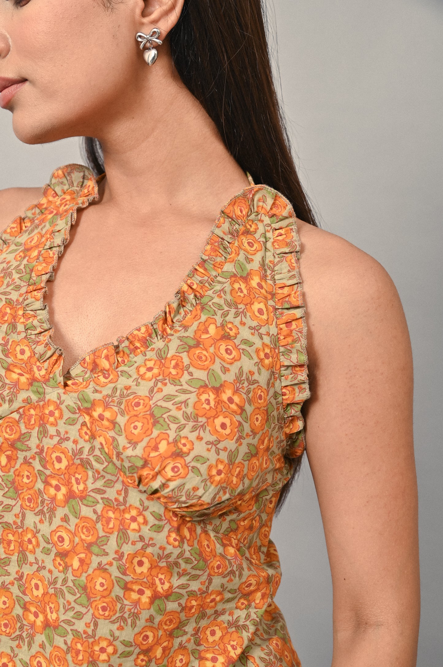 Ruffled neckline detail on cotton halter top